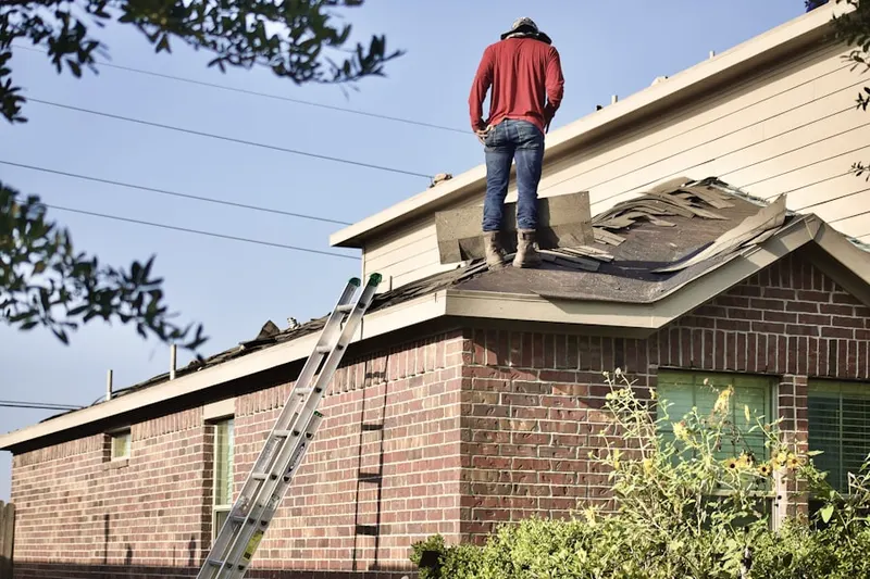 Professional roofer working on a residential roof in Sulgrave Manor
